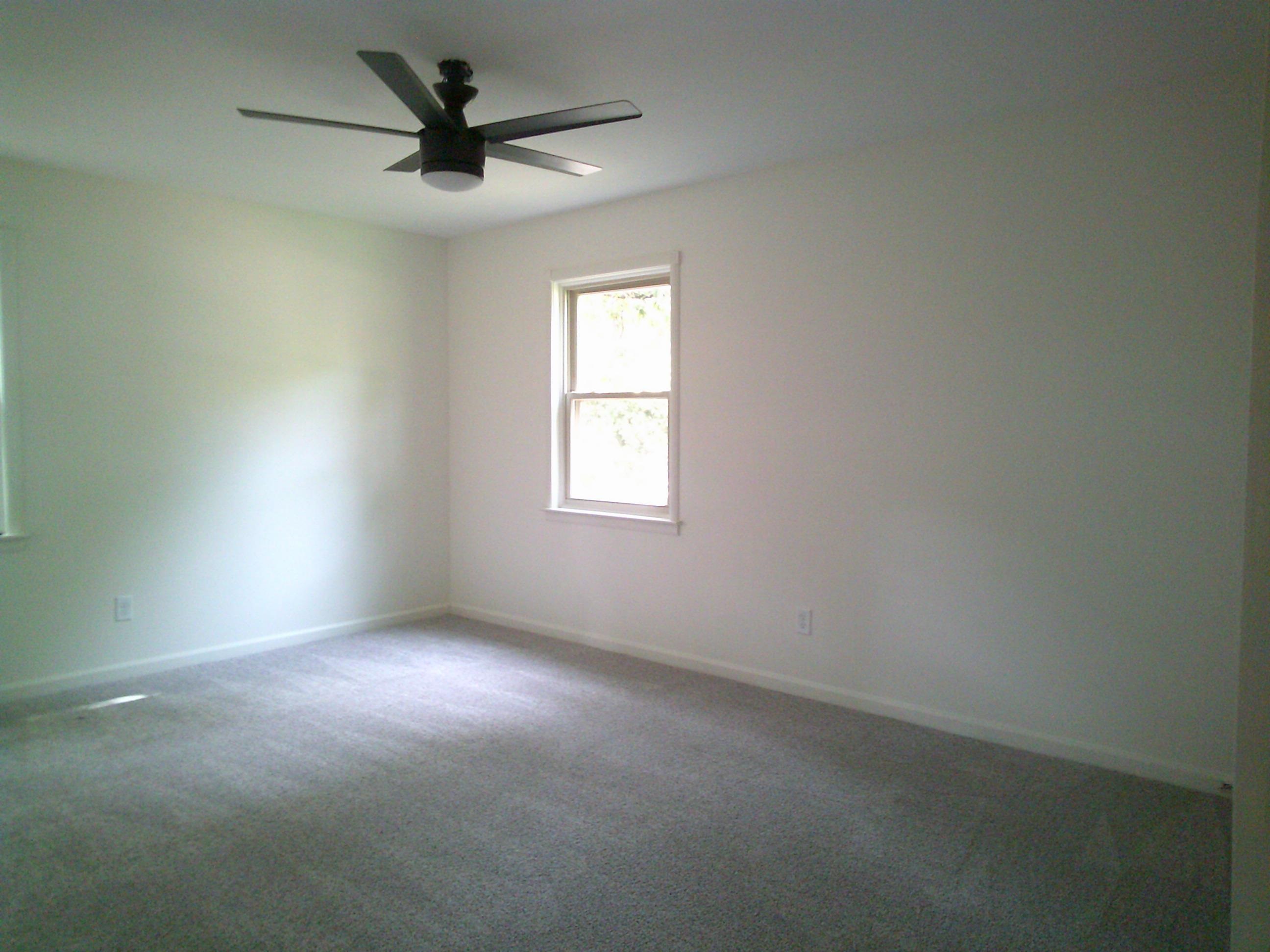235 Morton Road Collierville, TN 38017 - Photo 10 of 18 an empty room with a chandelier fan and windows