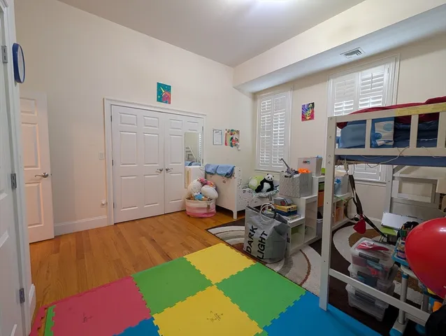 a bed room with a bed a window and a television