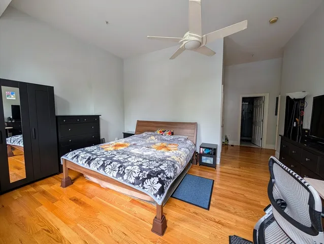 a bedroom with a bed and a dresser in it