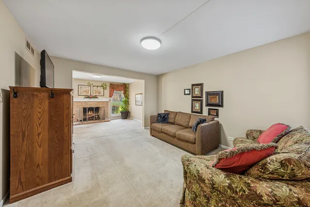 a living room with furniture window and a flat screen tv