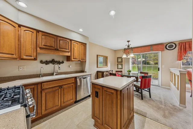 a kitchen with a sink a counter top space and stainless steel appliances