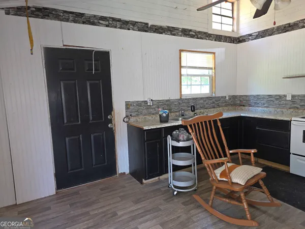 a view of a kitchen with a table and chairs