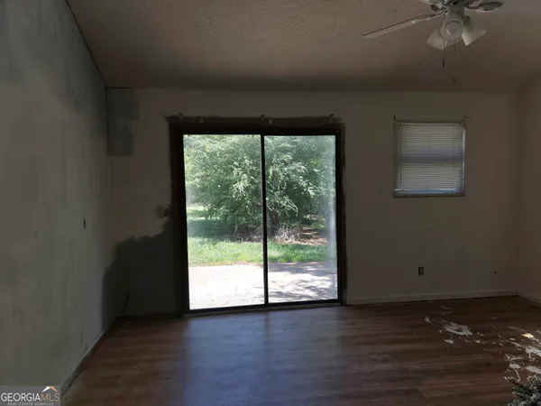 a view of a livingroom with wooden floor and a window