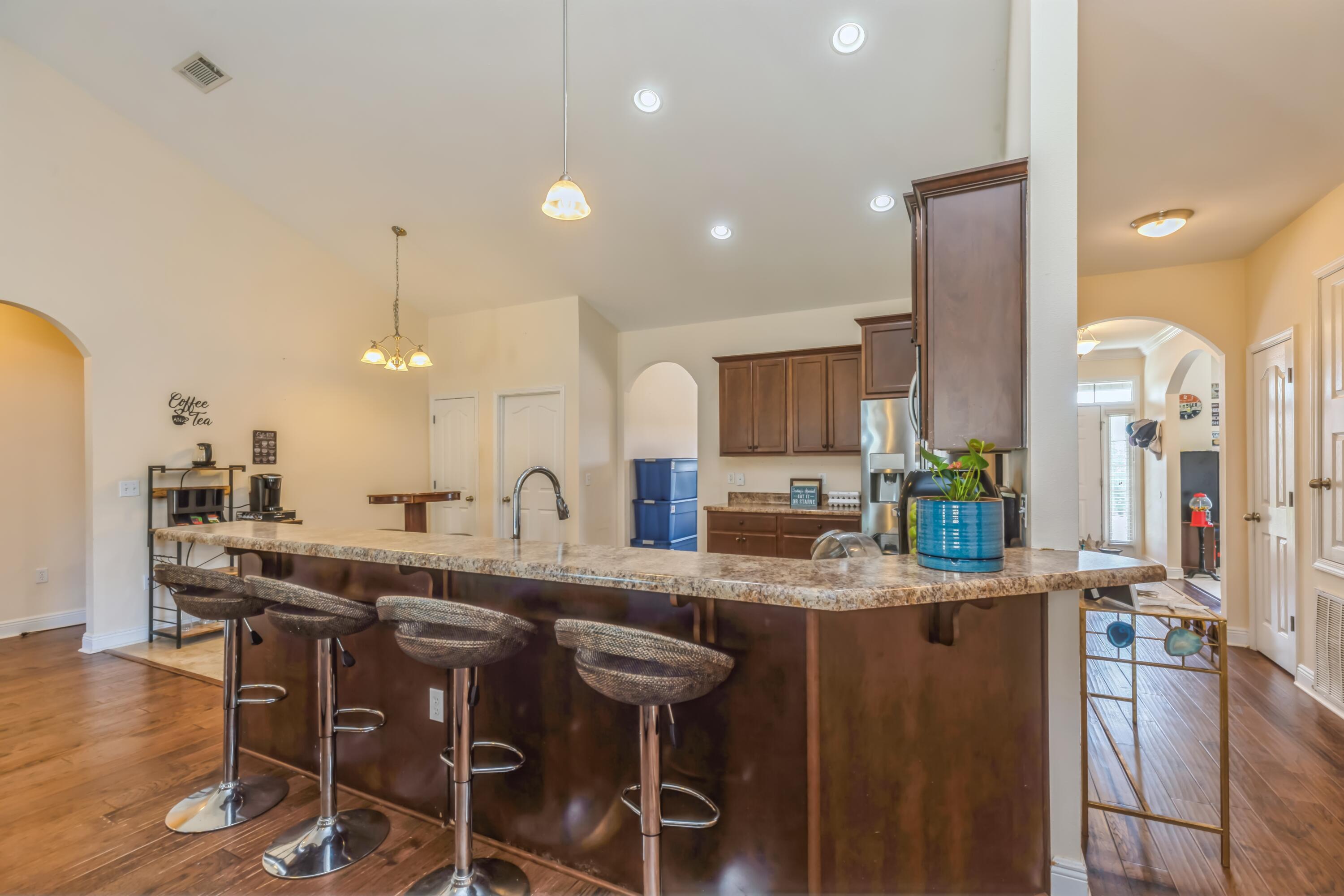 609 Rowan Circle Crestview, FL 32536 - Photo 14 of 37 a kitchen with stainless steel appliances kitchen island granite countertop a sink and cabinets