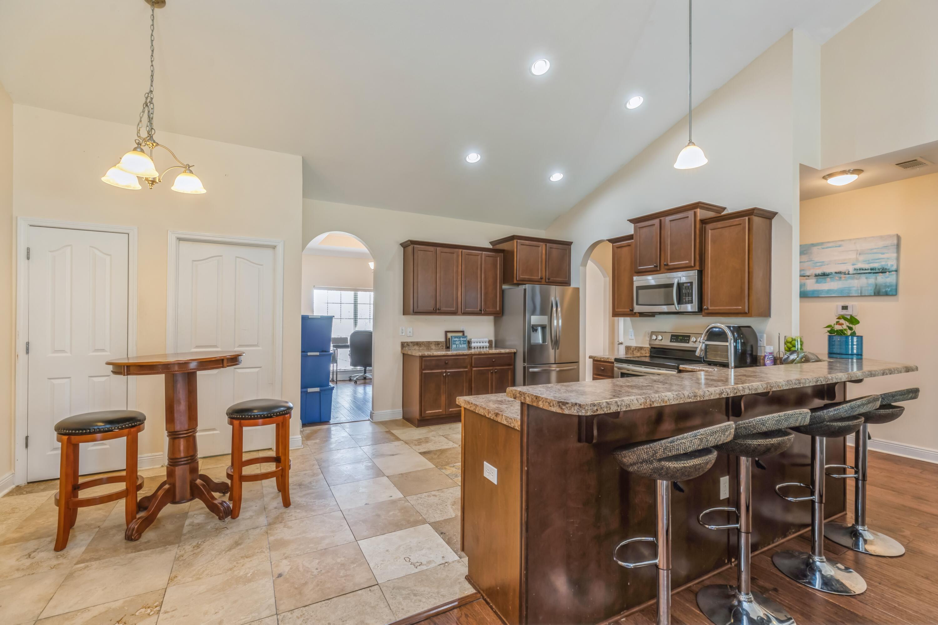 609 Rowan Circle Crestview, FL 32536 - Photo 15 of 37 a large kitchen with a table and chairs in it