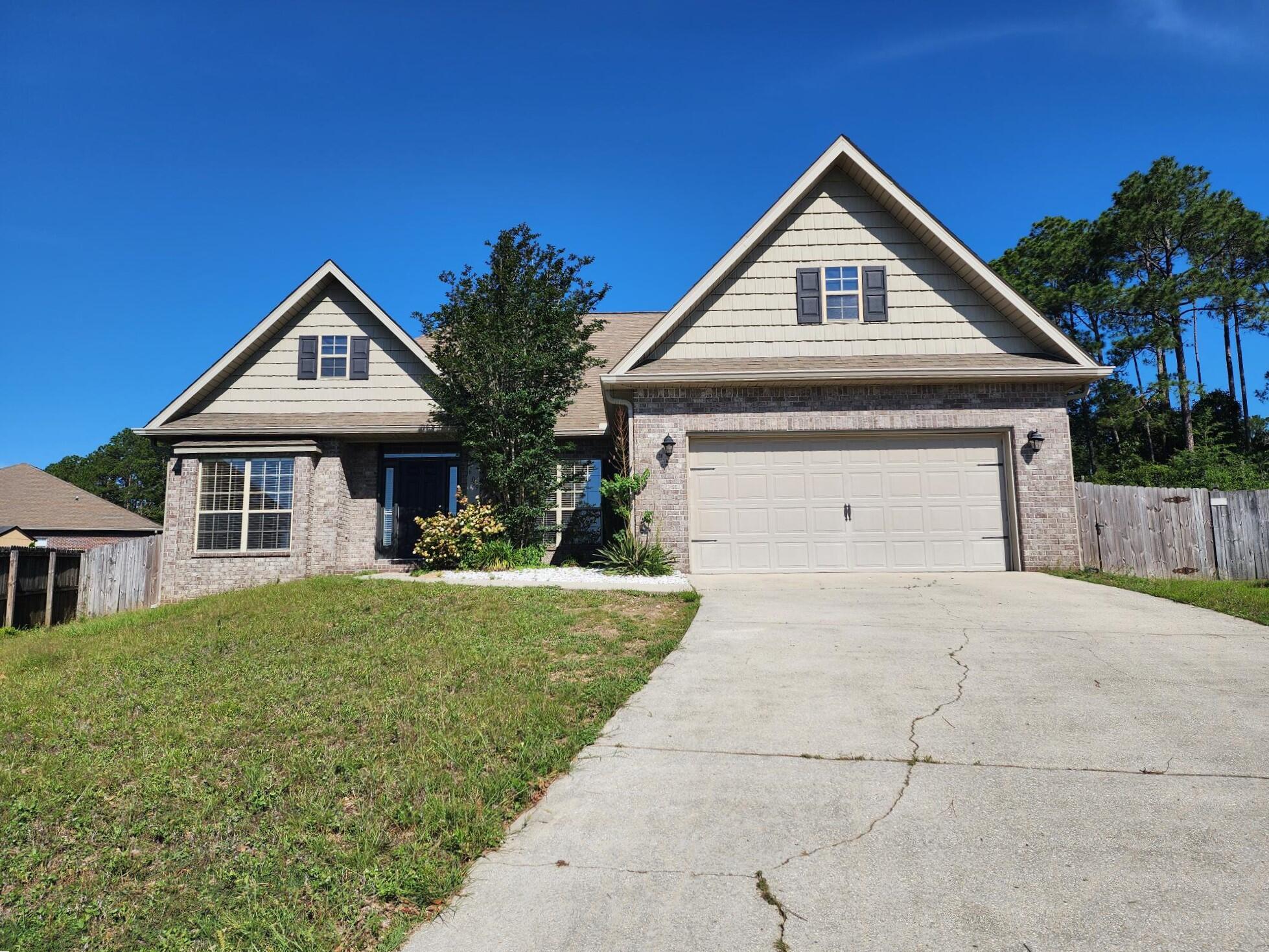 609 Rowan Circle Crestview, FL 32536 - Photo 2 of 37 a front view of a house with a yard and garage