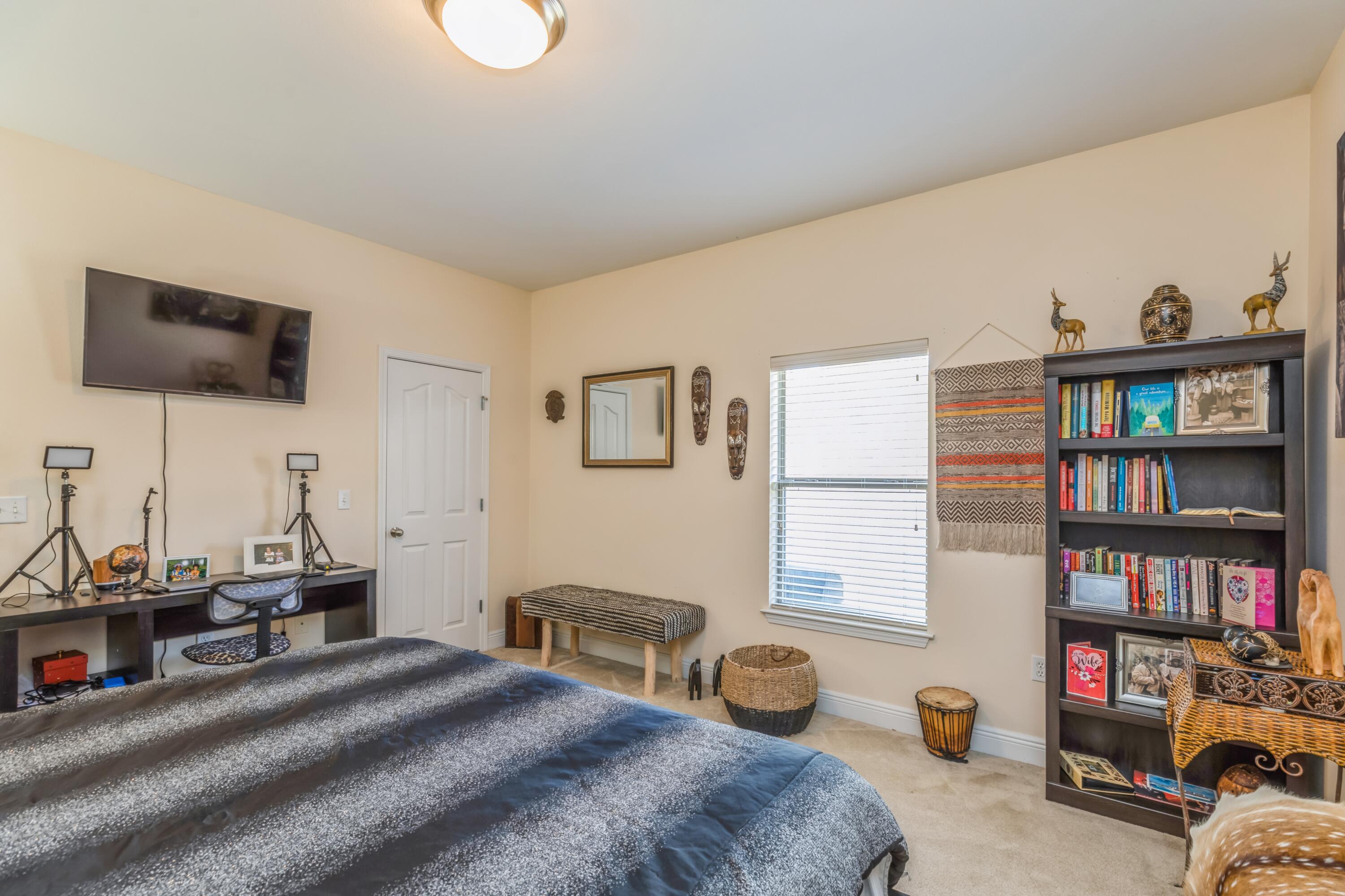 609 Rowan Circle Crestview, FL 32536 - Photo 22 of 37 a bedroom with bed a computer on the desk and a book shelf