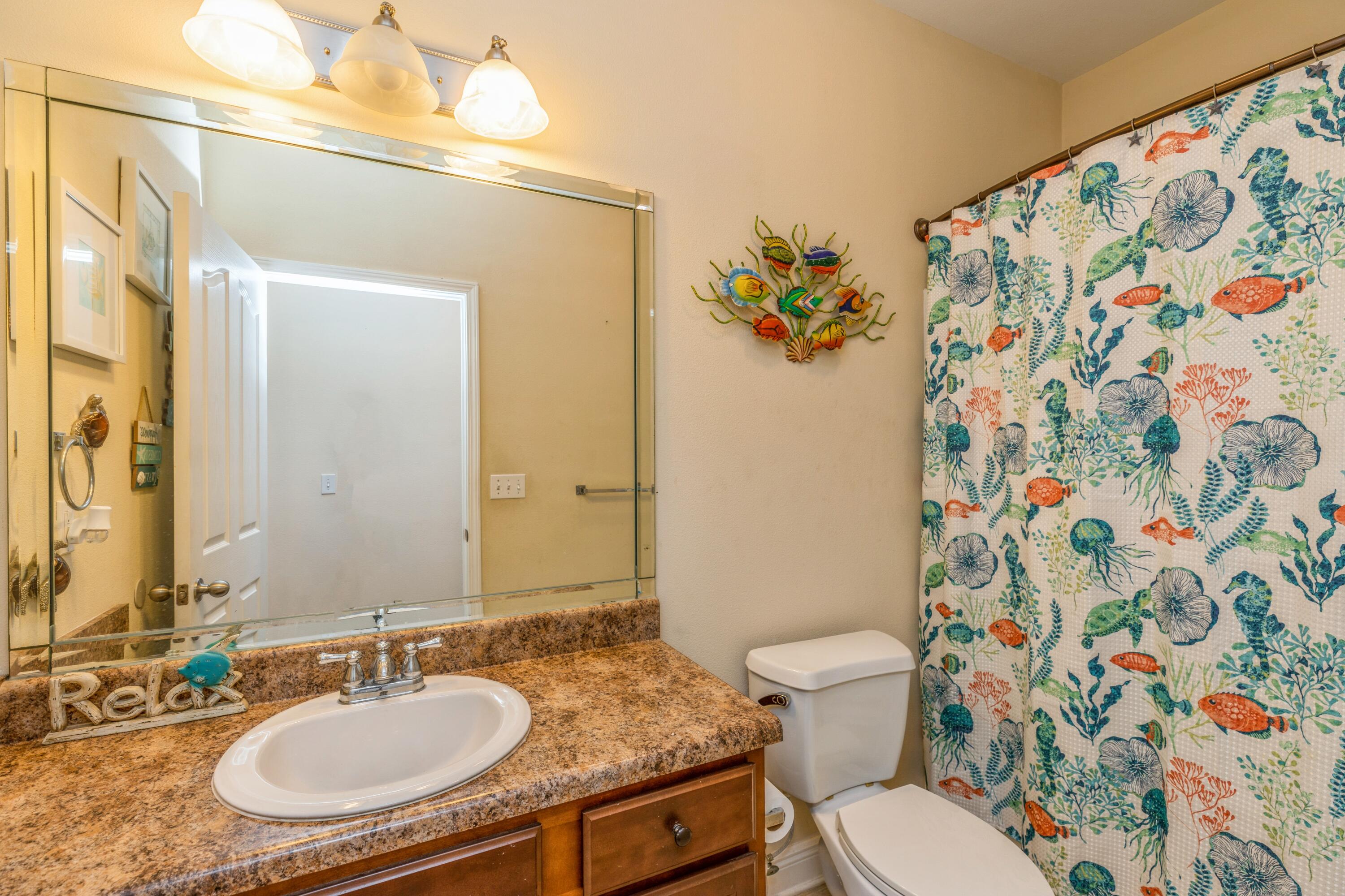 609 Rowan Circle Crestview, FL 32536 - Photo 25 of 37 a bathroom with a granite countertop sink a toilet and a mirror