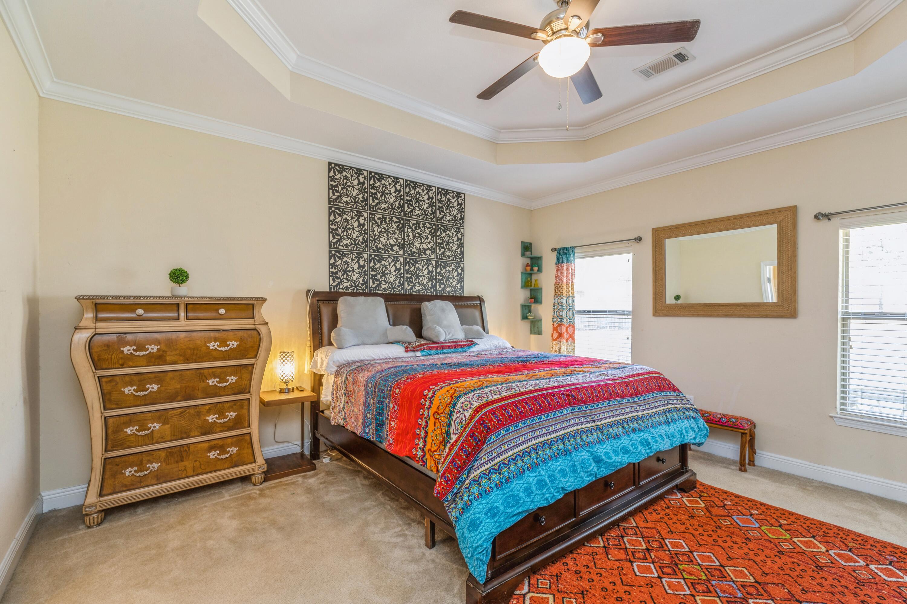 609 Rowan Circle Crestview, FL 32536 - Photo 27 of 37 a bedroom with a bed and a chandelier