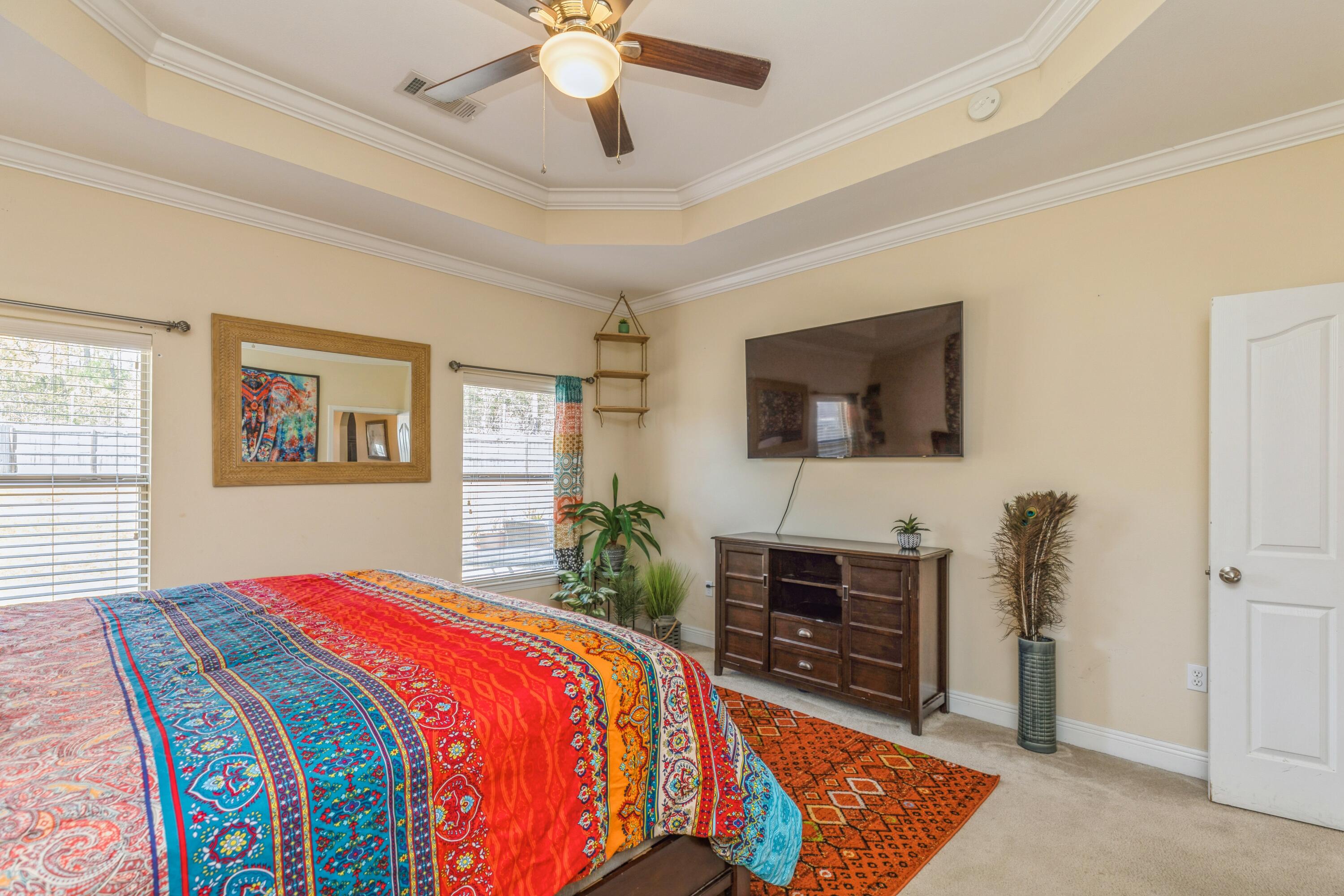 609 Rowan Circle Crestview, FL 32536 - Photo 28 of 37 a bedroom with a bed and a flat screen tv