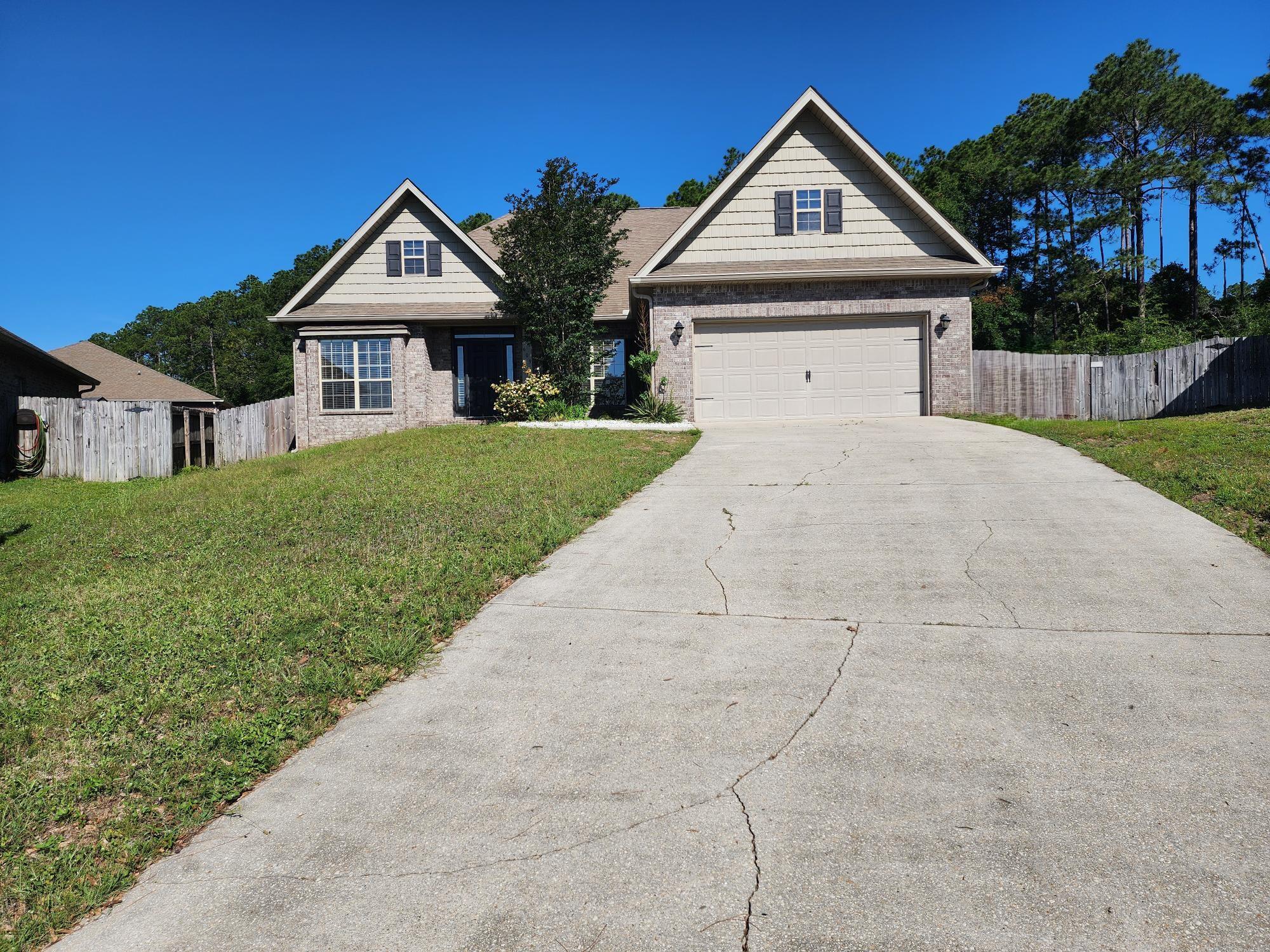 609 Rowan Circle Crestview, FL 32536 - Photo 3 of 37 a front view of a house with garden