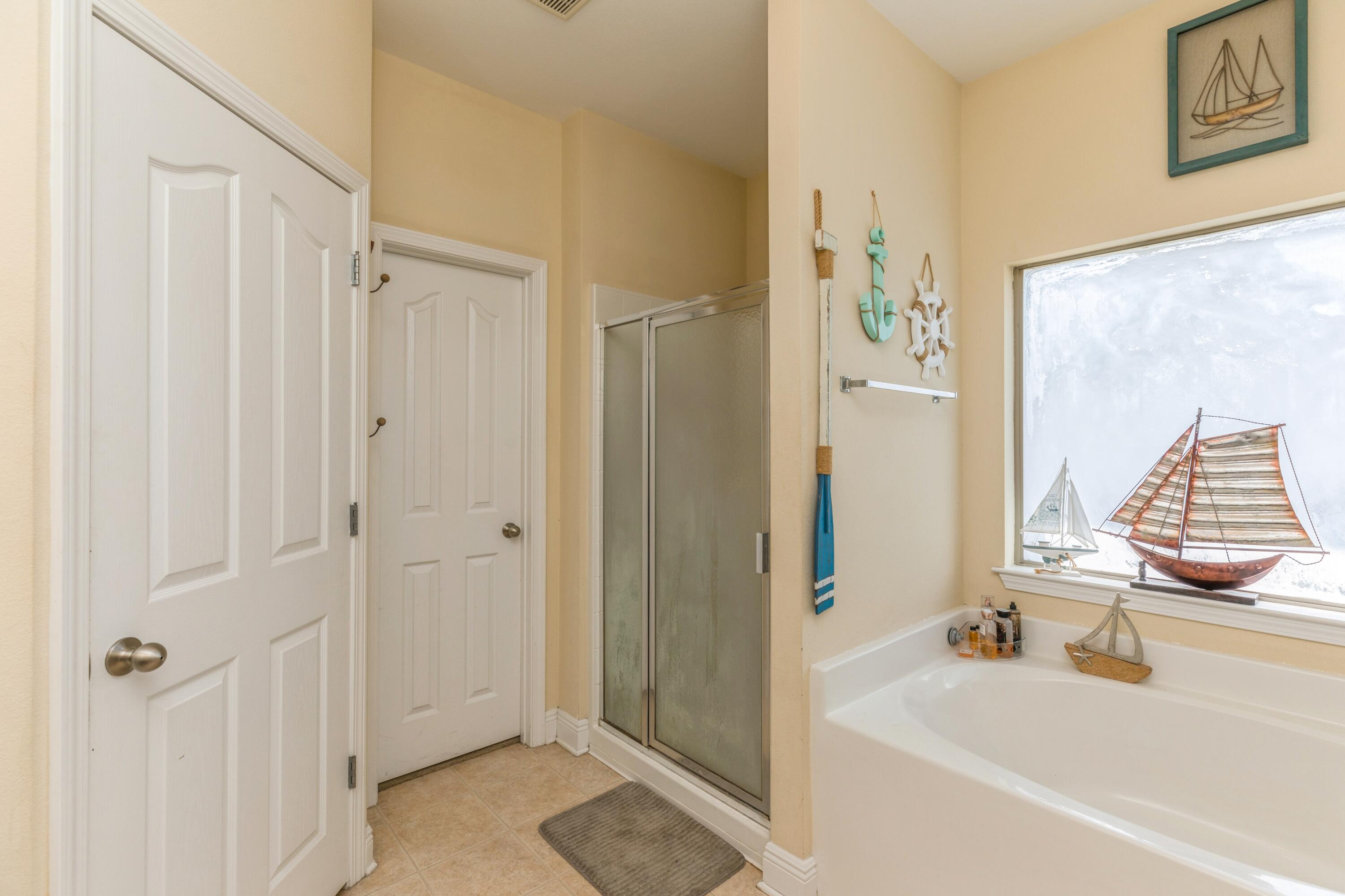609 Rowan Circle Crestview, FL 32536 - Photo 31 of 37 a bathroom with a bathtub and a shower