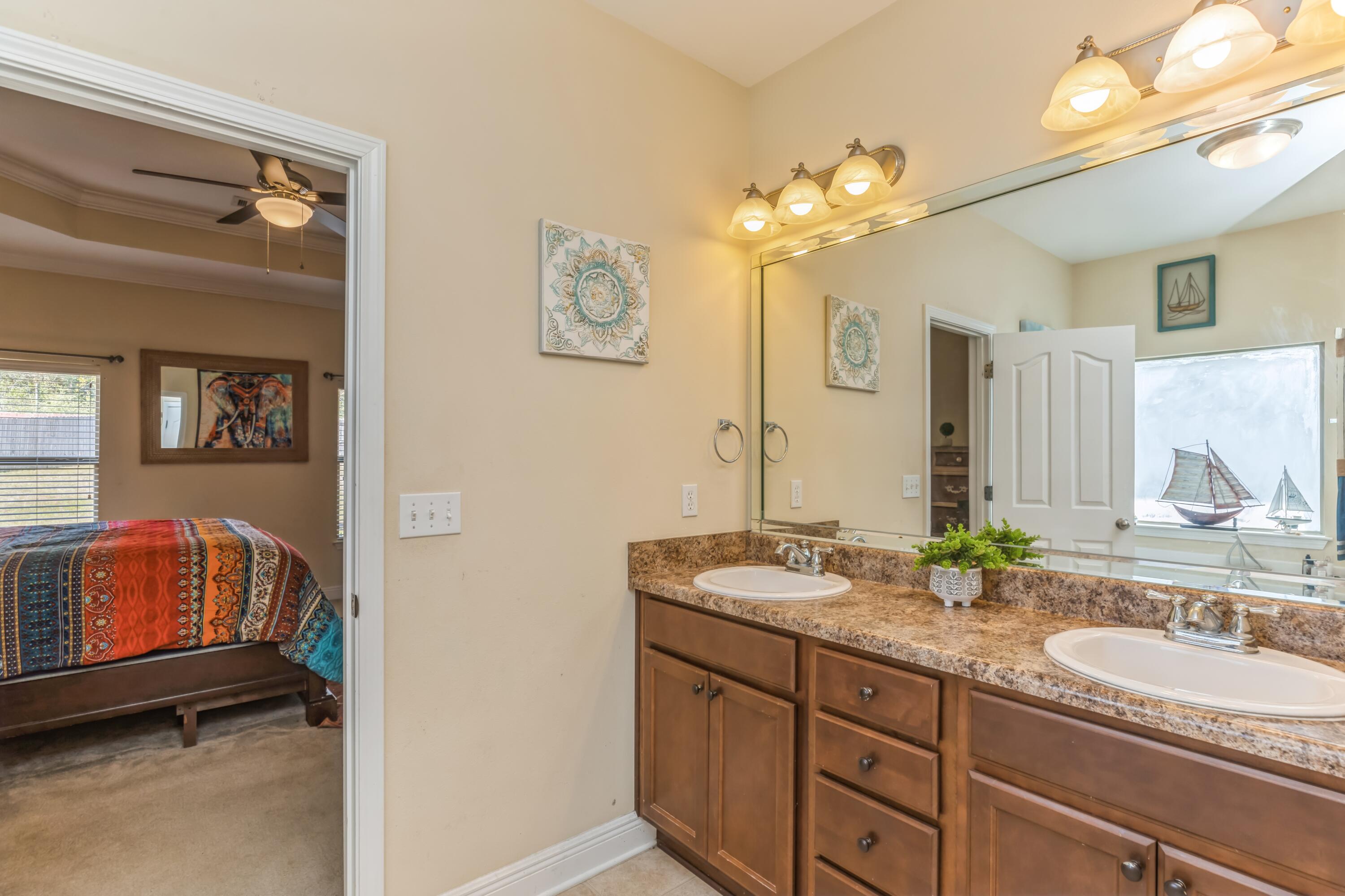 609 Rowan Circle Crestview, FL 32536 - Photo 32 of 37 a bathroom with a double vanity sink and a mirror