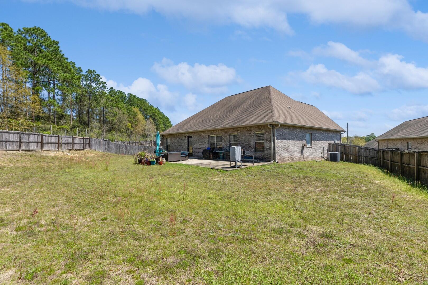 609 Rowan Circle Crestview, FL 32536 - Photo 35 of 37 a front view of house with yard and trees in the background