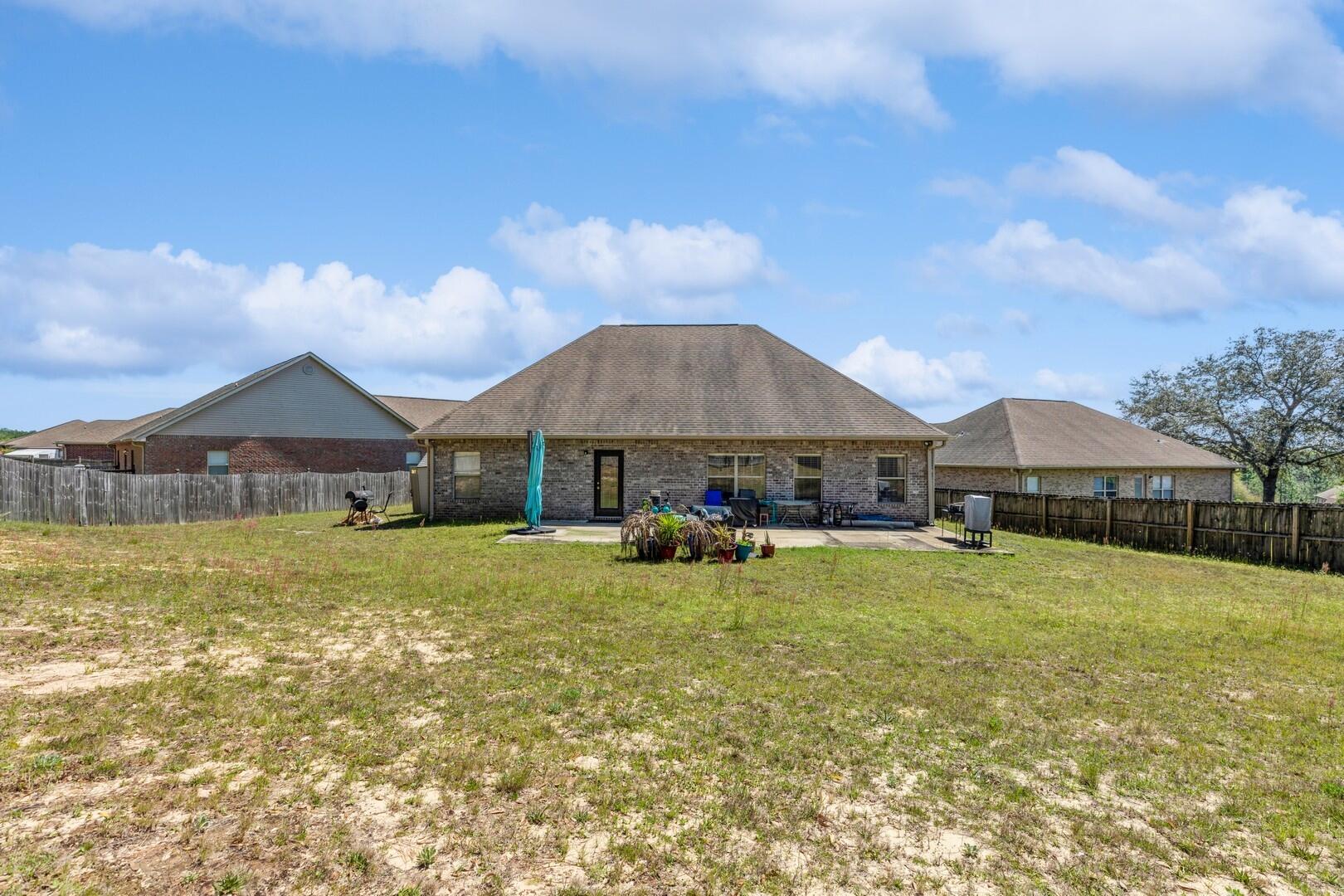 609 Rowan Circle Crestview, FL 32536 - Photo 36 of 37 a swimming pool is sitting in front of a house