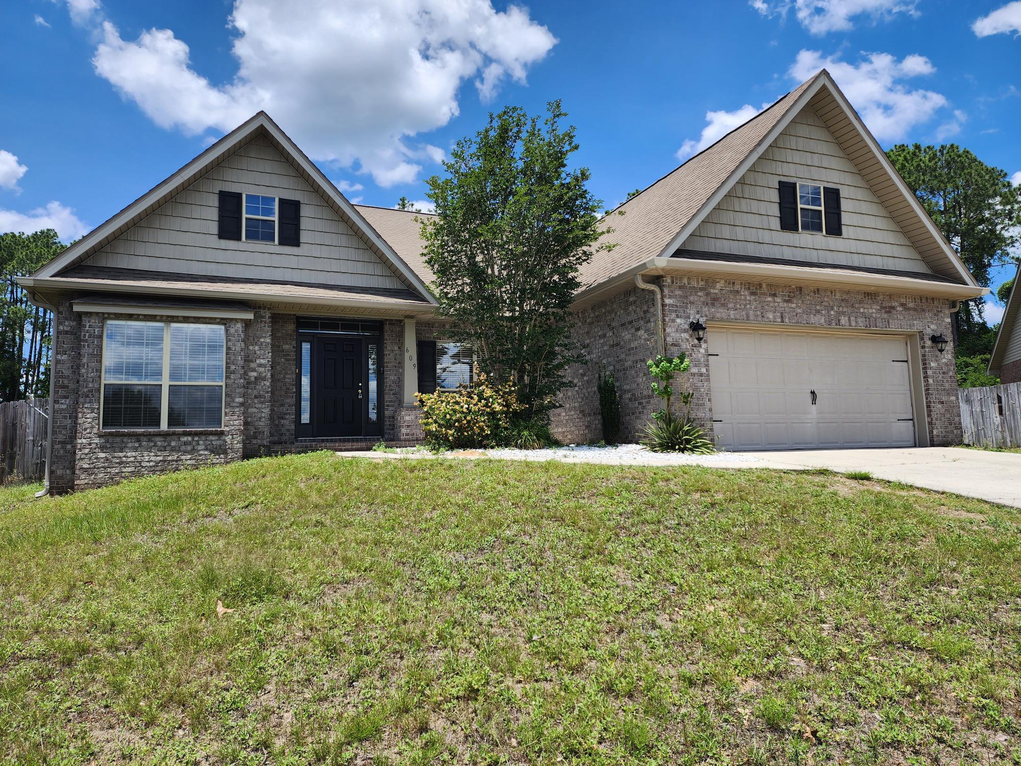 609 Rowan Circle Crestview, FL 32536 - Photo 4 of 37 a front view of a house with a yard