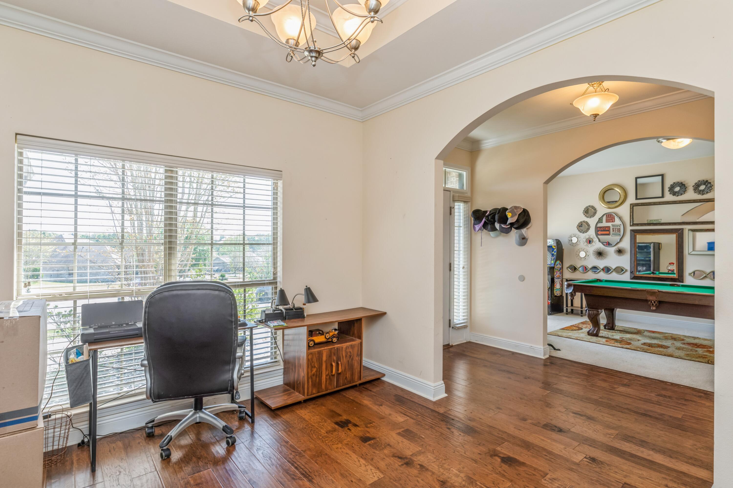 609 Rowan Circle Crestview, FL 32536 - Photo 6 of 37 a workspace with wooden floor and a large window