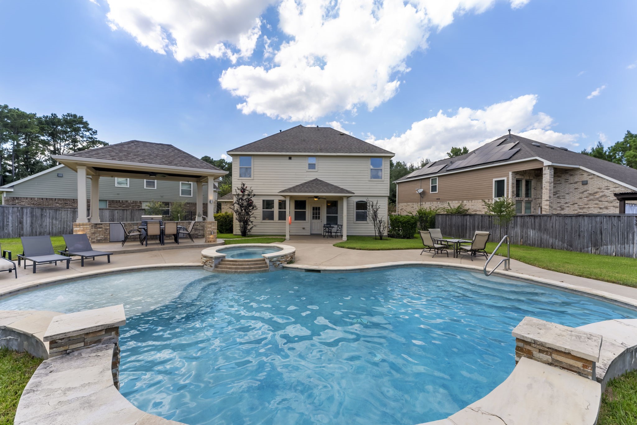 a view of house with swimming pool yard fire pit and outdoor seating