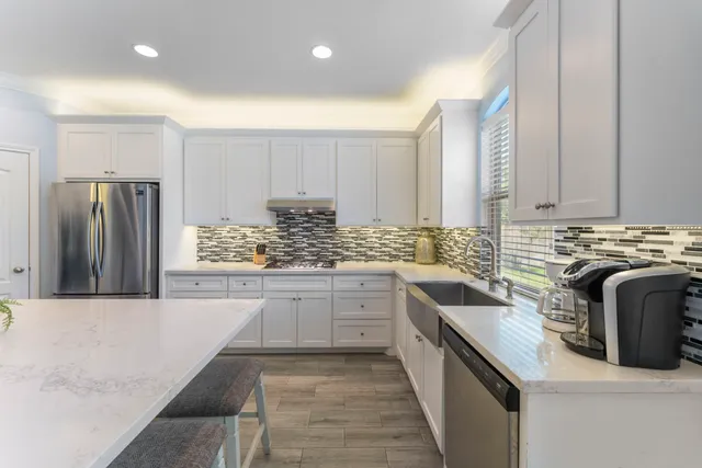 a kitchen with a refrigerator and a sink