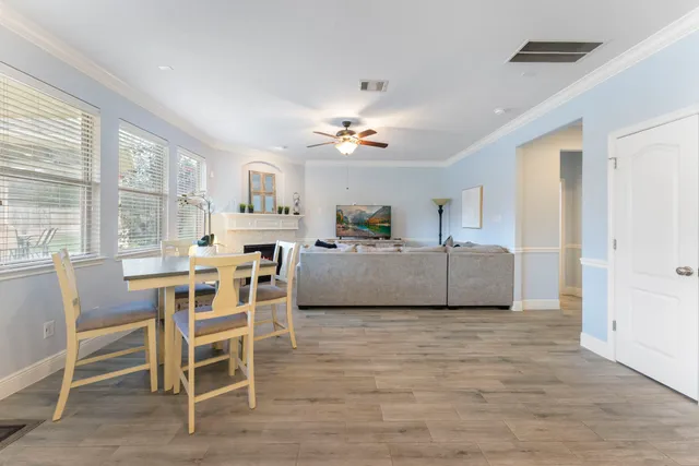 a living room with furniture a dining table and a fireplace