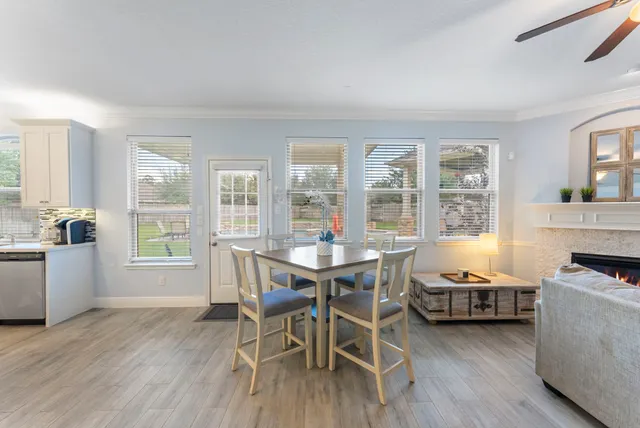 a view of a dining room with furniture a chandelier and wooden floor