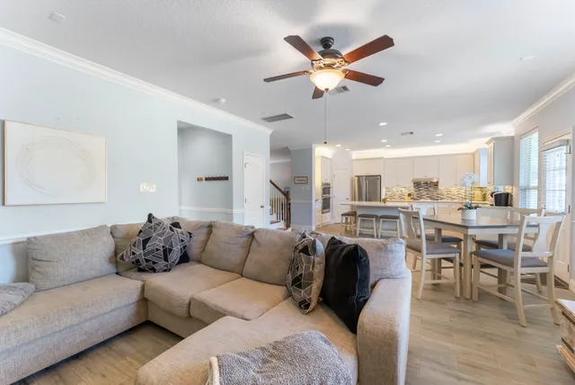 a living room with furniture kitchen view and a dining table