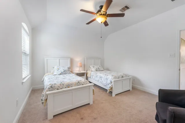 a bedroom with bed and window