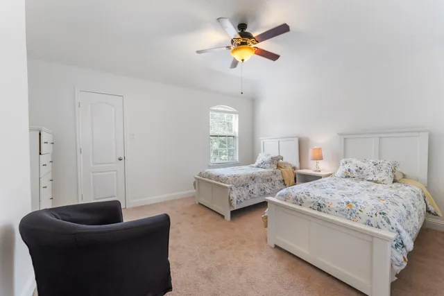 a bedroom with a bed couch and window