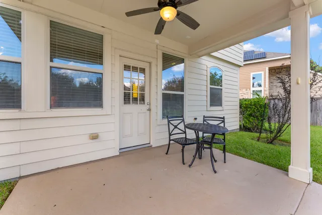 a view of a patio with table and chairs and potted plants