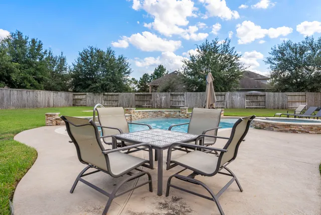 a view of a chairs and table in patio