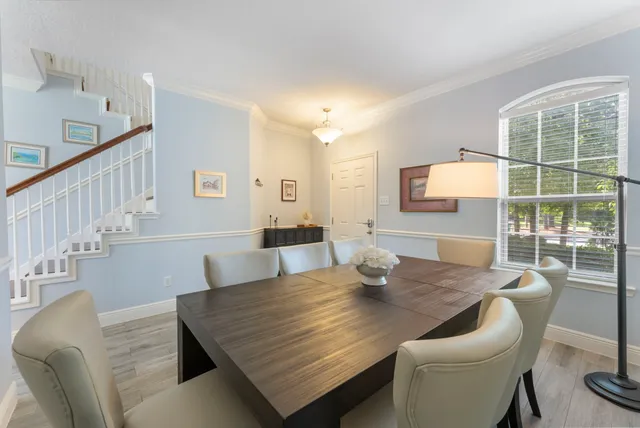 a view of a dining room with furniture and wooden floor