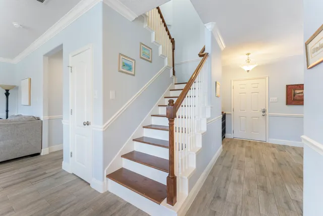 a view of a hallway view with wooden floor and staircase