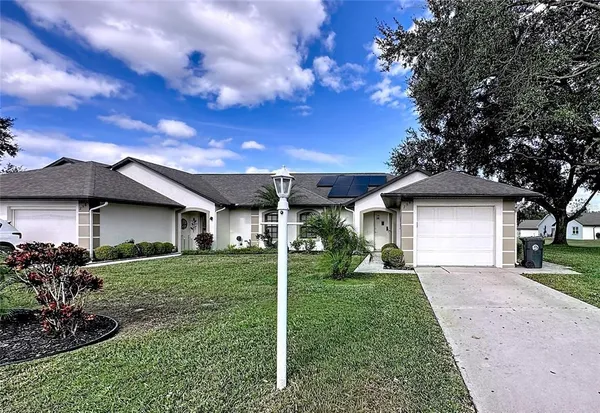 a front view of a house with a garden and yard