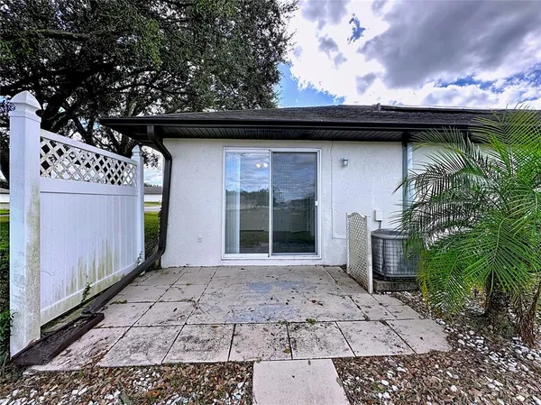 a view of a house with a yard and sitting area