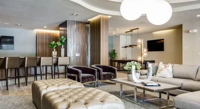 a living room with furniture and a dining table