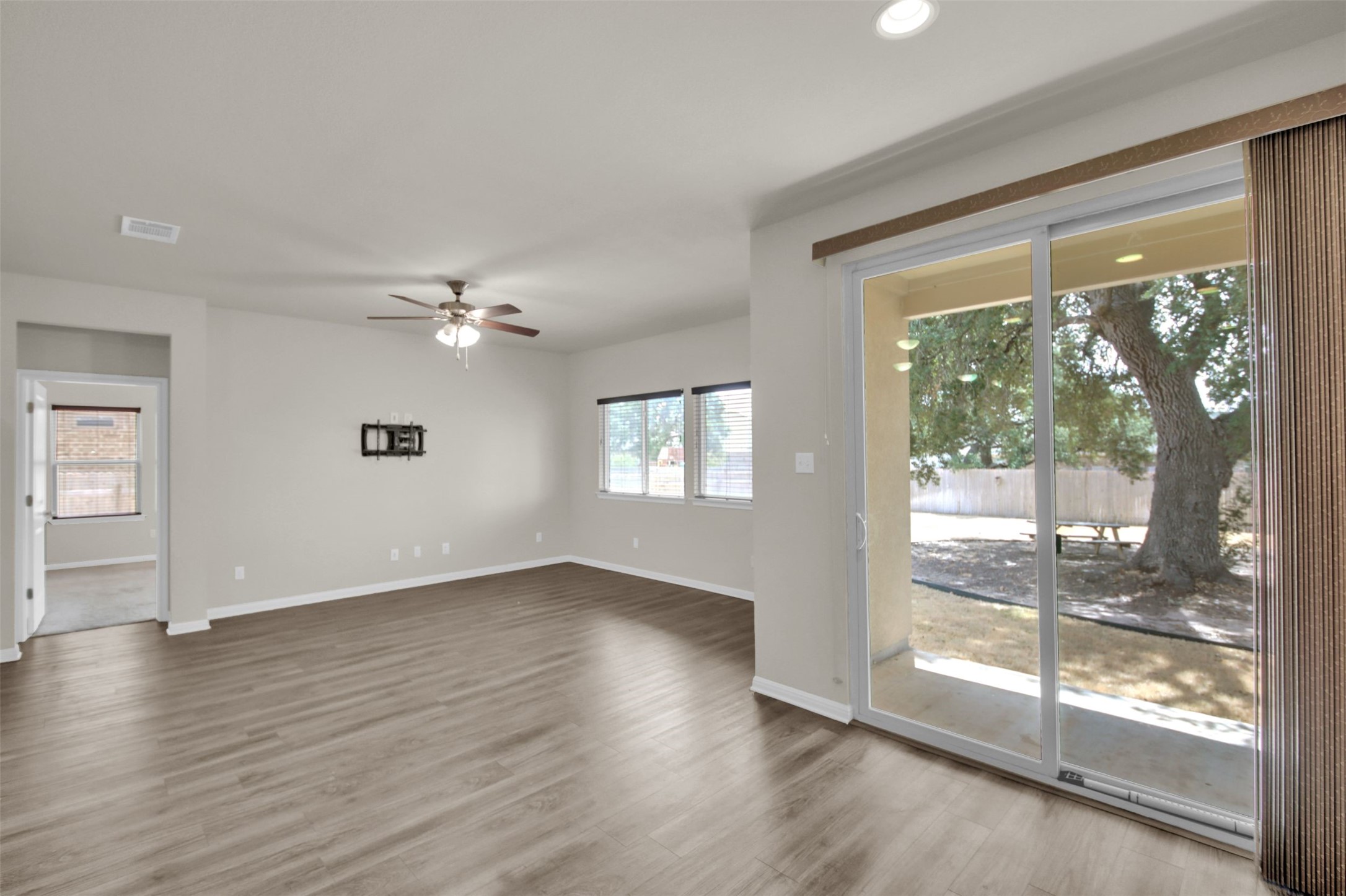 1829 Chickasaw Run Leander, TX 78641 - Photo 14 of 40 a view of an empty room with wooden floor and a window