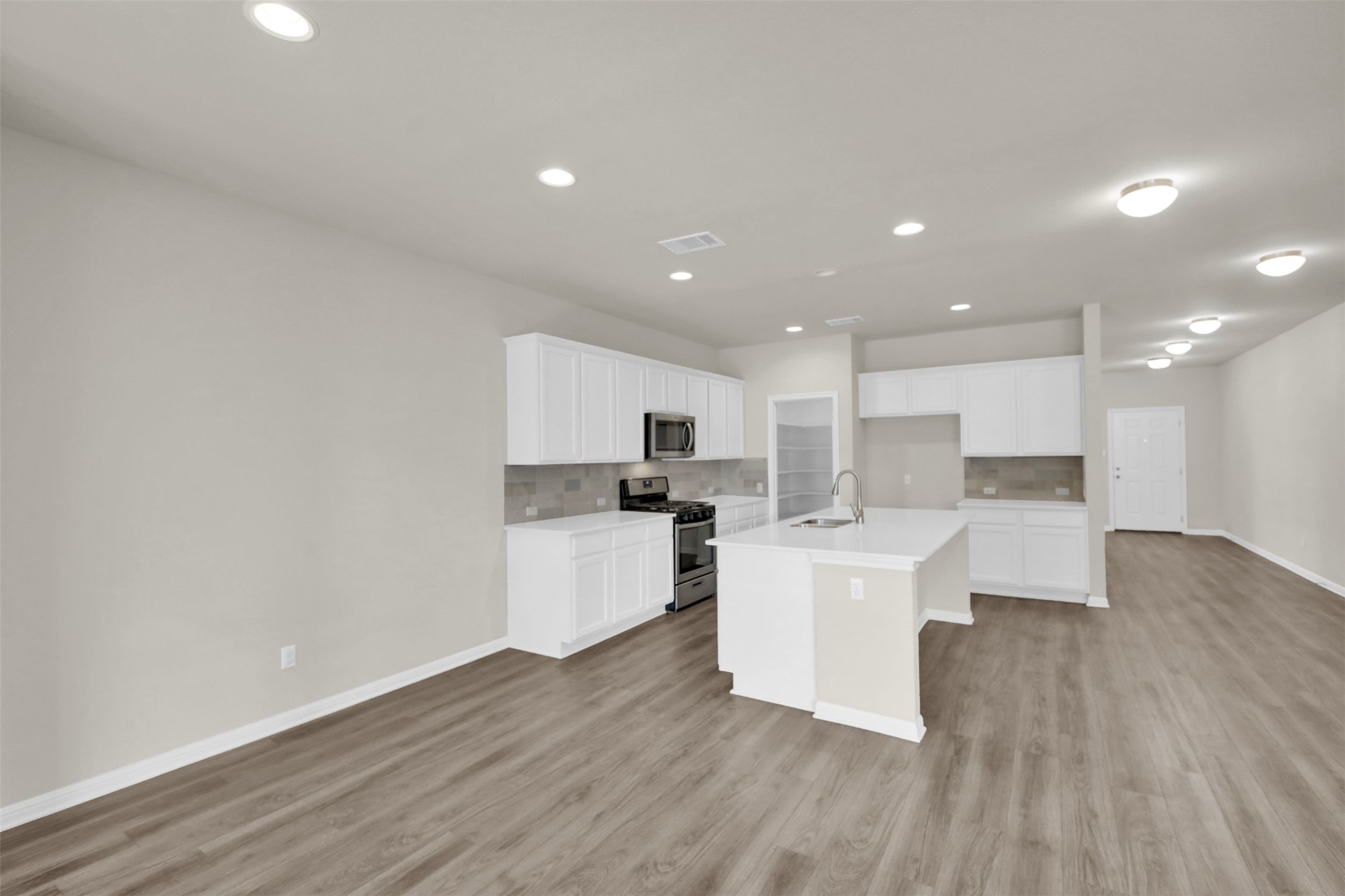 1829 Chickasaw Run Leander, TX 78641 - Photo 16 of 40 a large white kitchen with lots of counter top space and stainless steel appliances