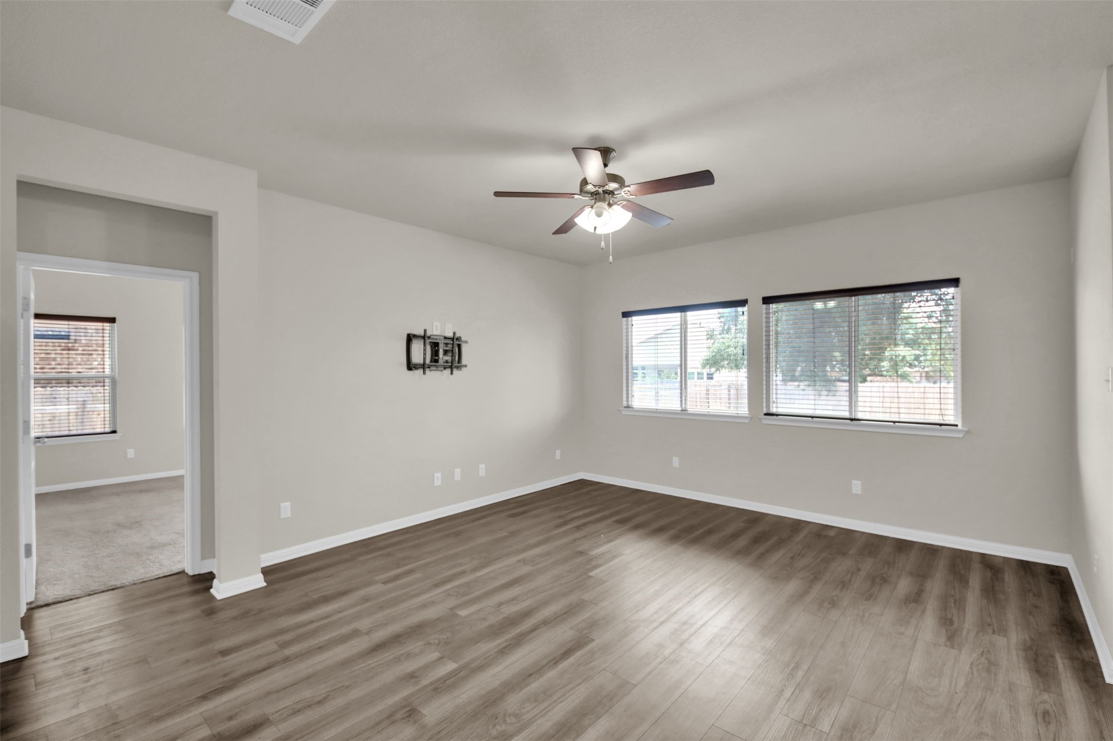 1829 Chickasaw Run Leander, TX 78641 - Photo 17 of 40 a view of empty room with wooden floor and fan