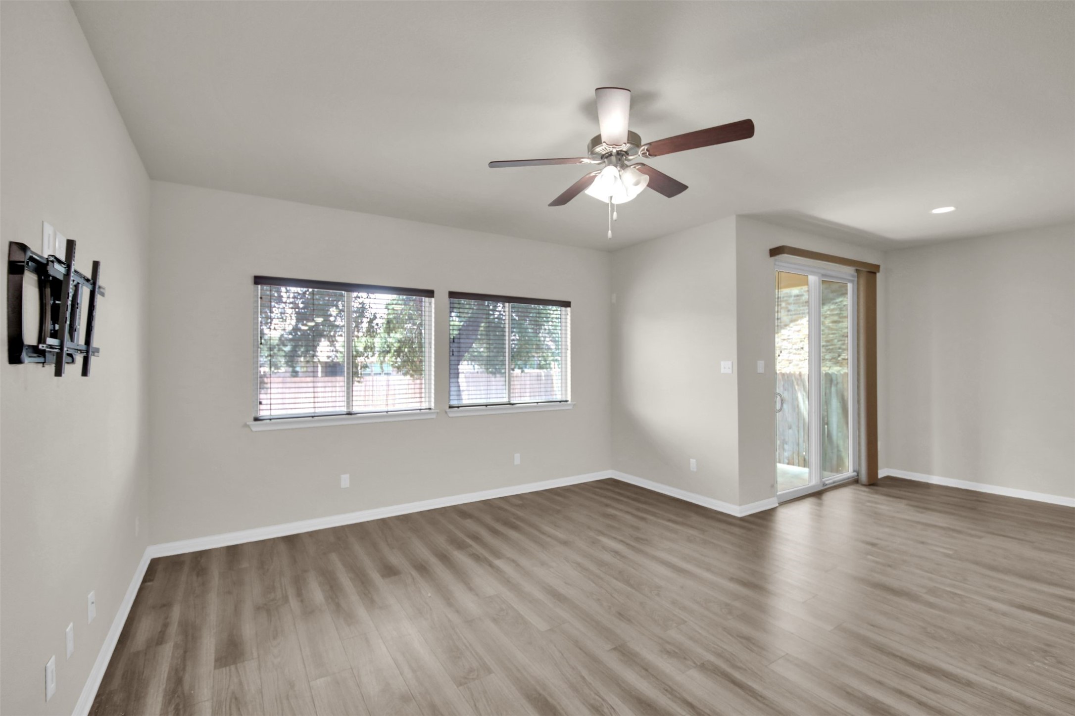 1829 Chickasaw Run Leander, TX 78641 - Photo 19 of 40 a view of an empty room with wooden floor and a window