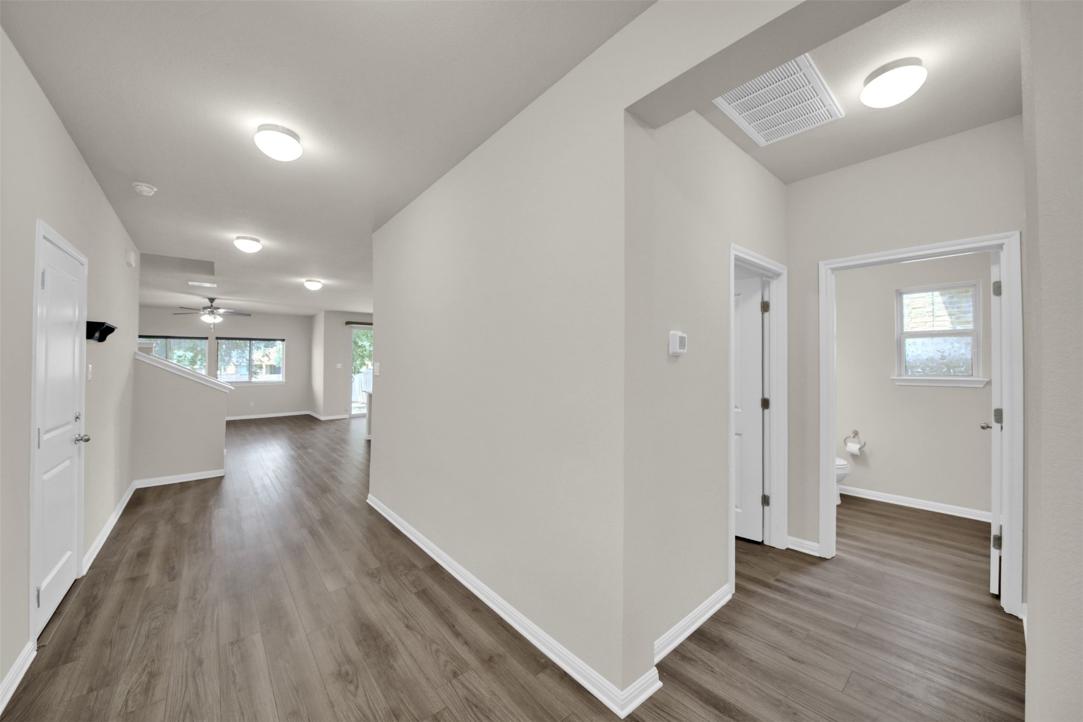 1829 Chickasaw Run Leander, TX 78641 - Photo 3 of 40 an empty room with wooden floor and windows