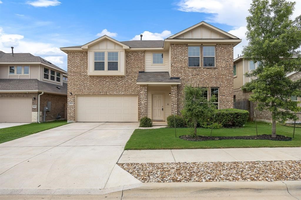 1829 Chickasaw Run Leander, TX 78641 - Photo 40 of 40 a front view of a house with a yard and garage