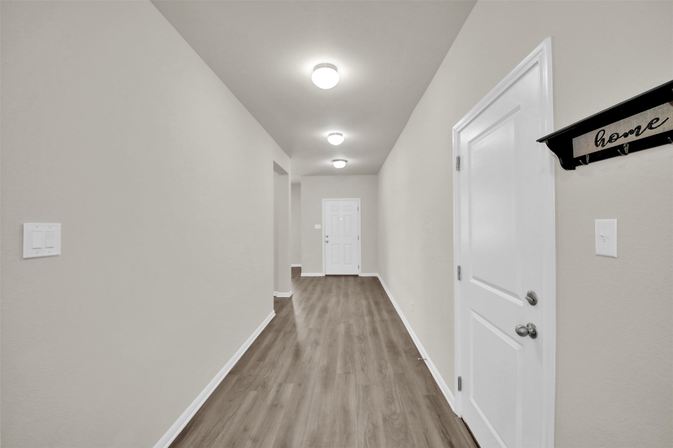 1829 Chickasaw Run Leander, TX 78641 - Photo 4 of 40 a view of a hallway with wooden floor