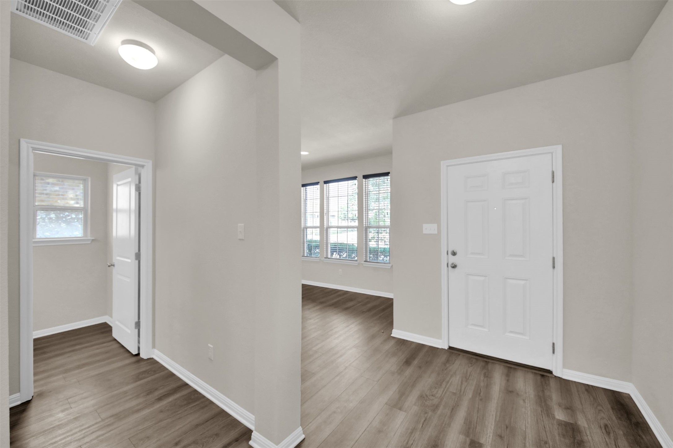 1829 Chickasaw Run Leander, TX 78641 - Photo 5 of 40 an empty room with wooden floor and windows