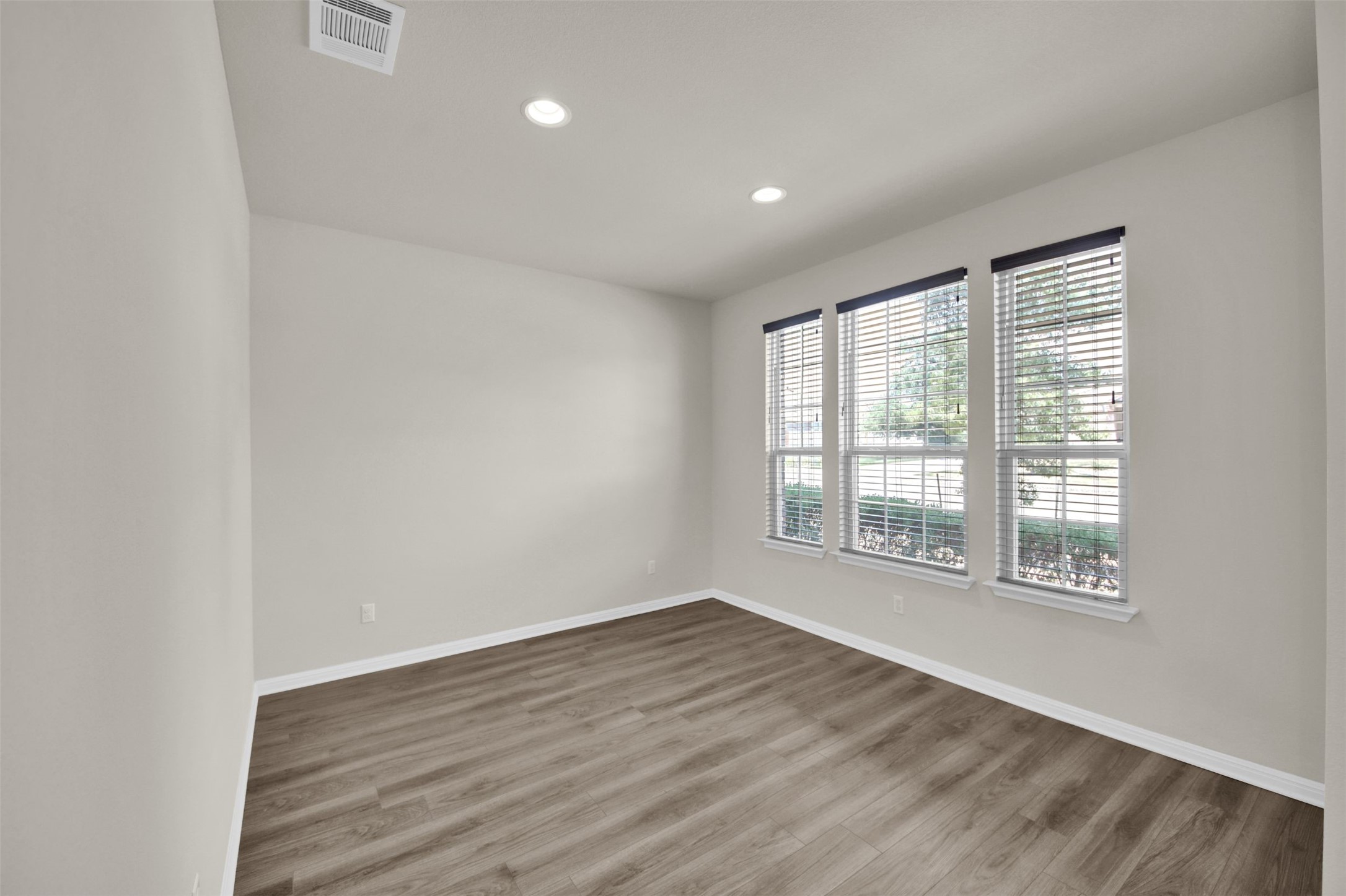 1829 Chickasaw Run Leander, TX 78641 - Photo 6 of 40 an empty room with wooden floor and windows