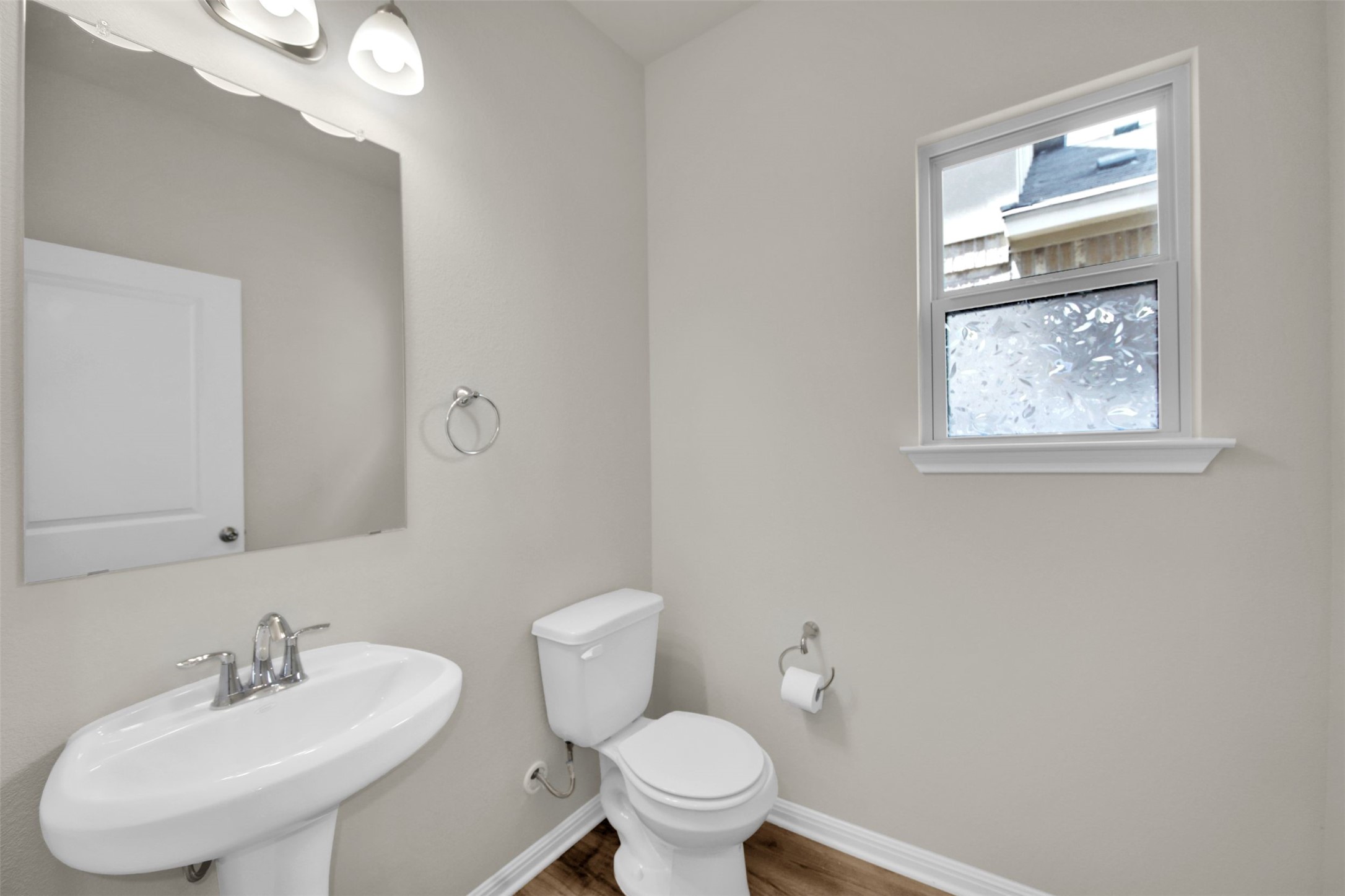 1829 Chickasaw Run Leander, TX 78641 - Photo 7 of 40 a bathroom with a toilet sink and mirror