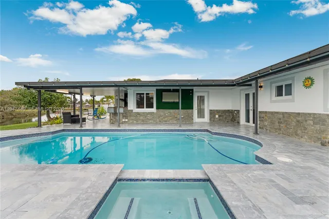 a view of a house with a yard and potted plants