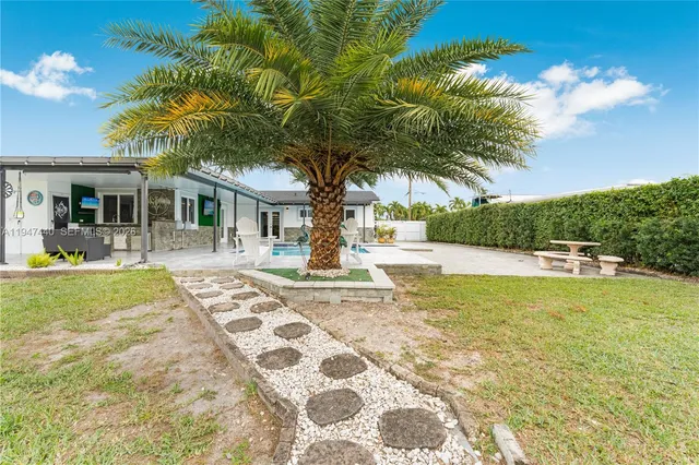 a front view of a house with a garden and a yard