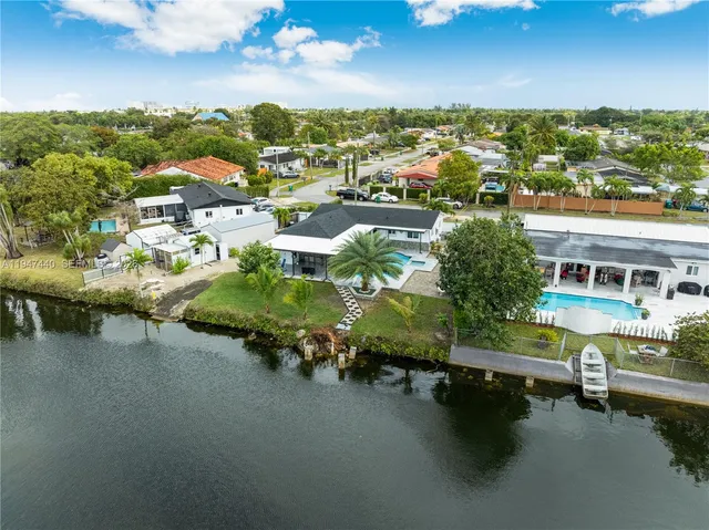 an aerial view of a house with a yard pool a patio and outdoor seating