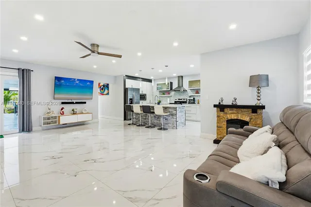 a living room with furniture and kitchen view