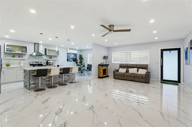 a living room with furniture and kitchen view